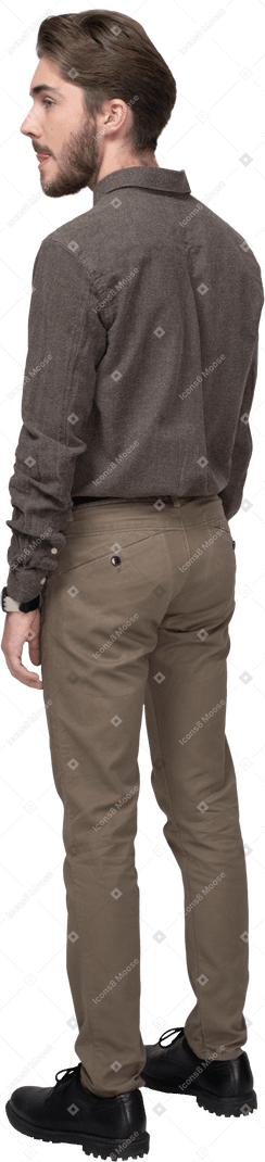 Three-quarter back of a young man in office clothing licking lips