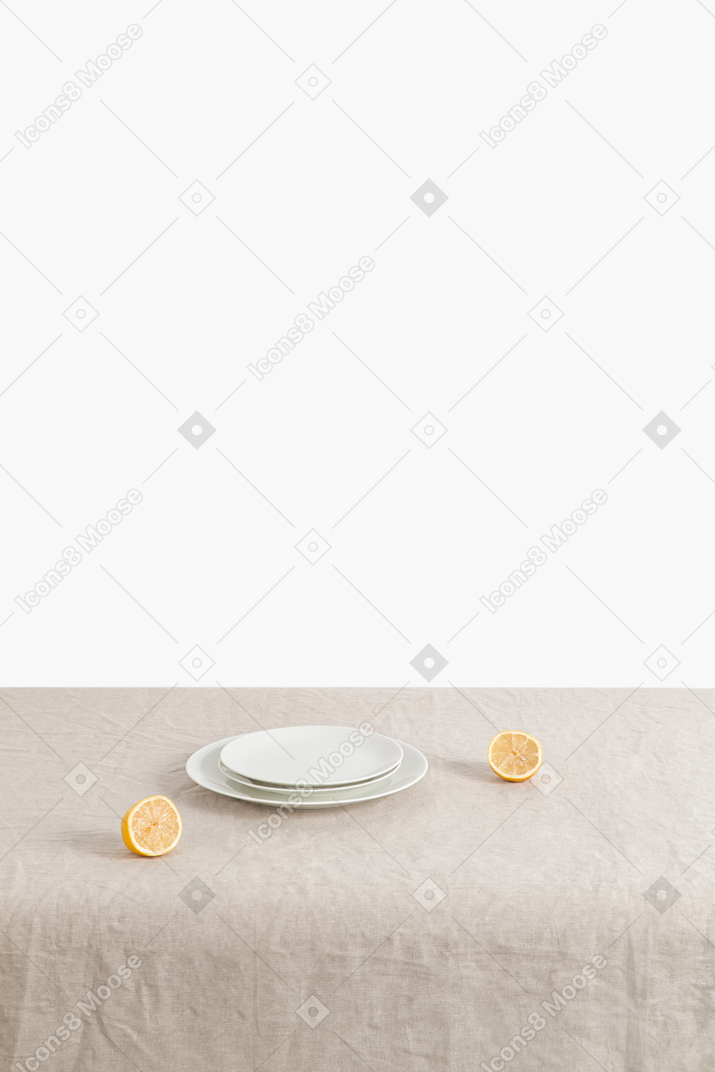 Few plates and lemons on the table