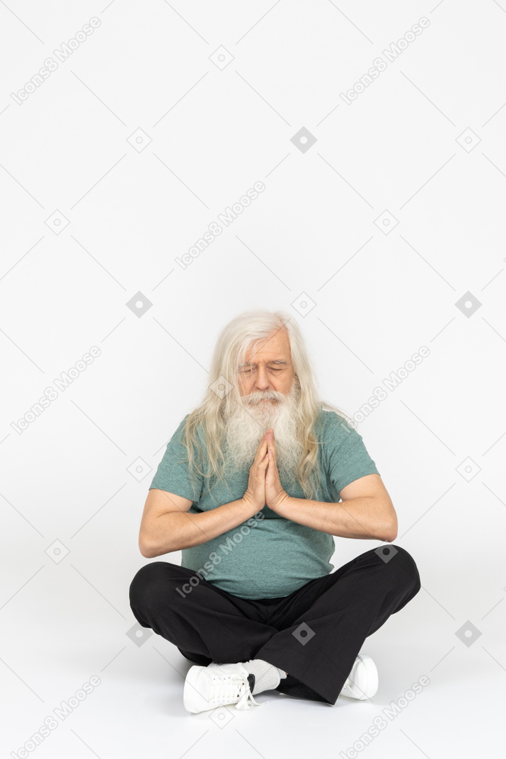 앉아서 기도하는 노인의 전면 모습