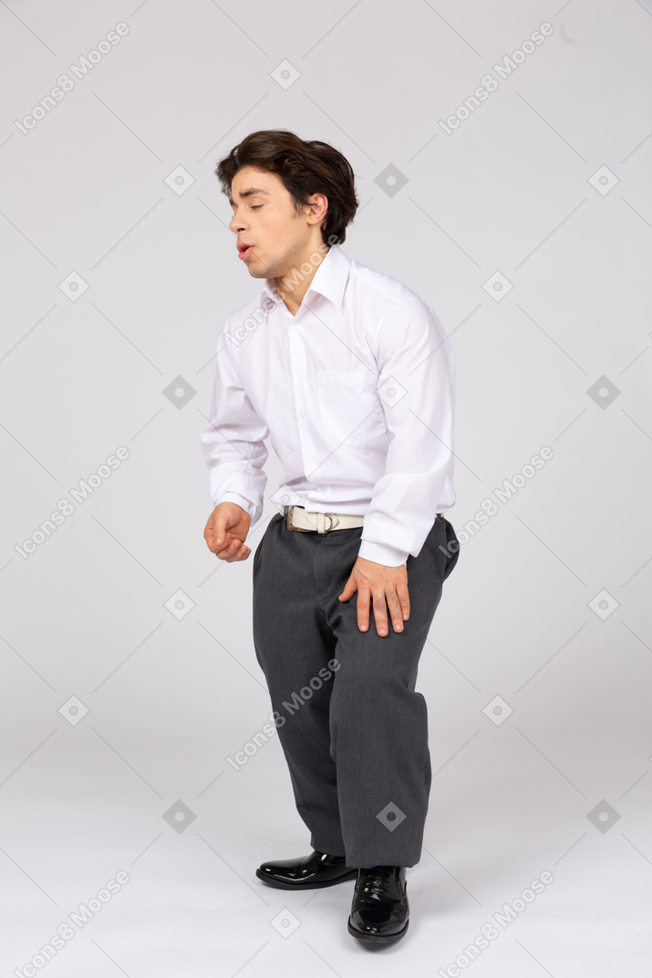 Side view of man with closed eyes feeling pain in leg