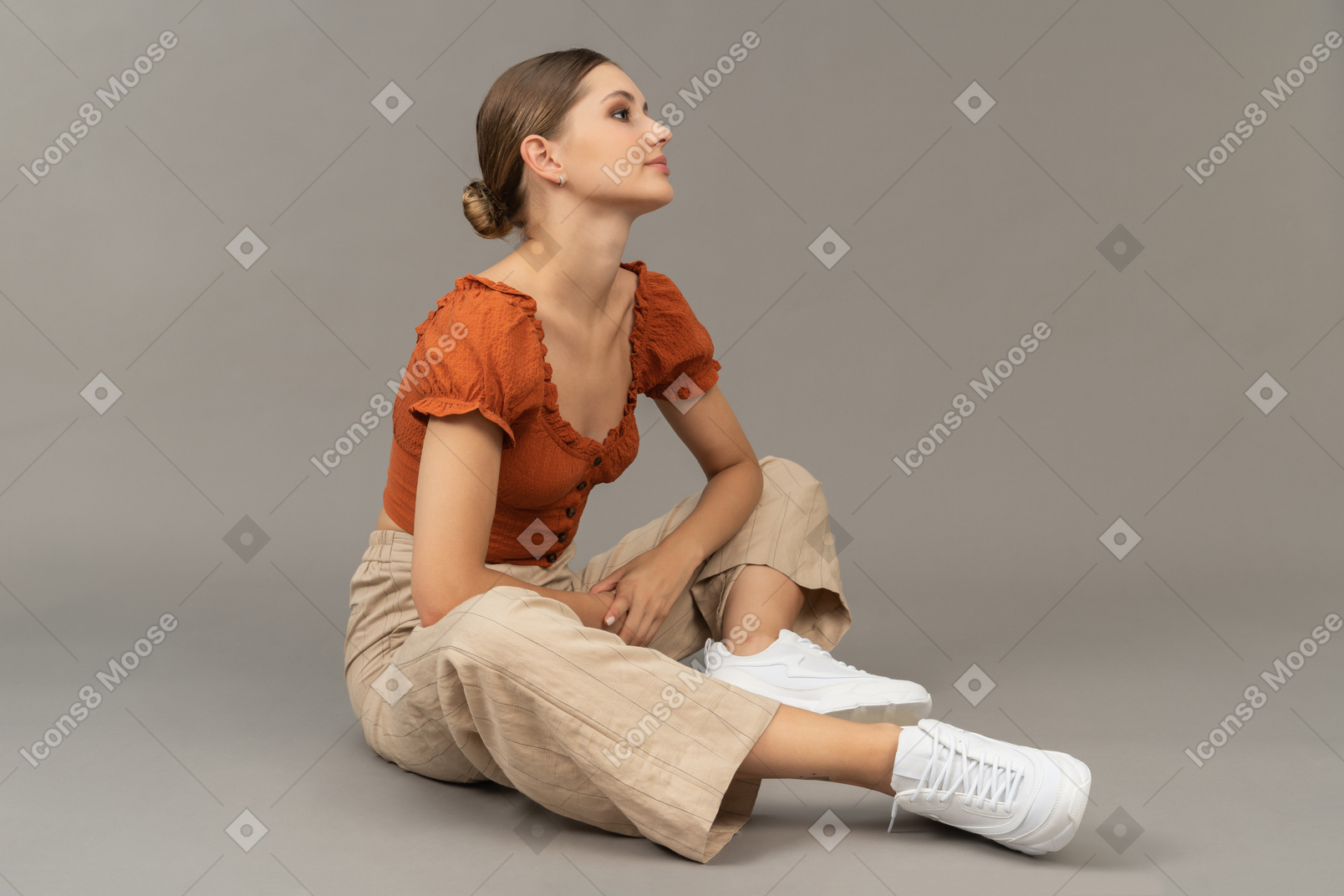 Young woman sits while looking away