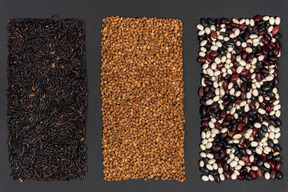 Three rectangles shaped of black rice buckwheat and multicolored beans