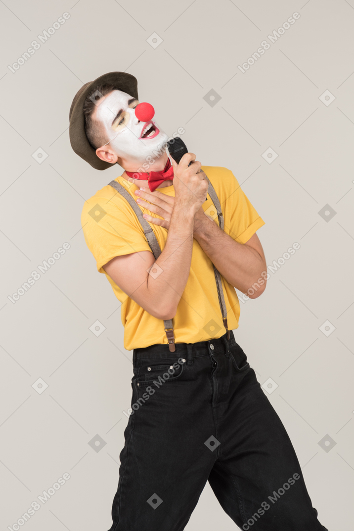 Male clown singing into a microphone