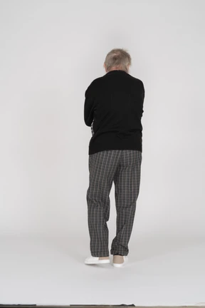 Rear view of a standing old man