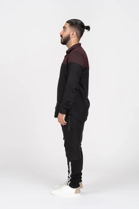 A young man posing sideways