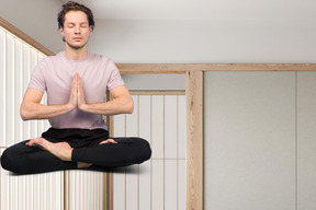 A man sitting in a yoga position with his eyes closed