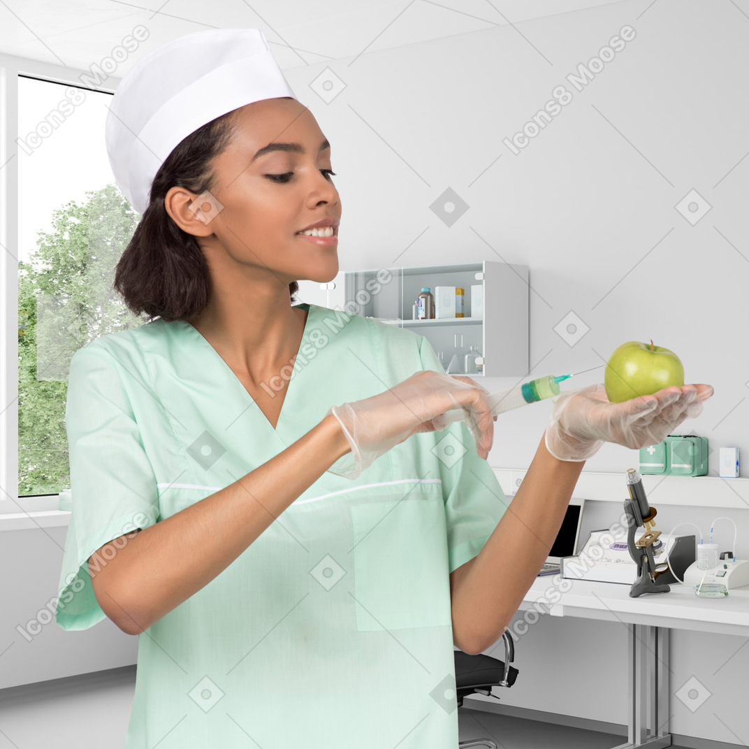 A female doctor injecting an apple in a lab