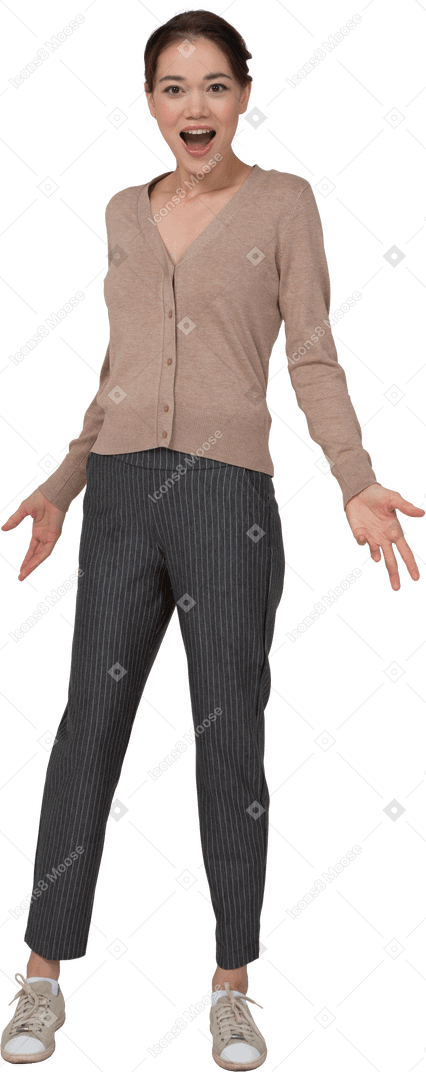 Front view of a pleased young lady in beige pullover outspreading her hands