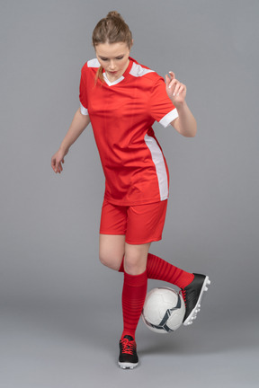 A female football player driving a ball