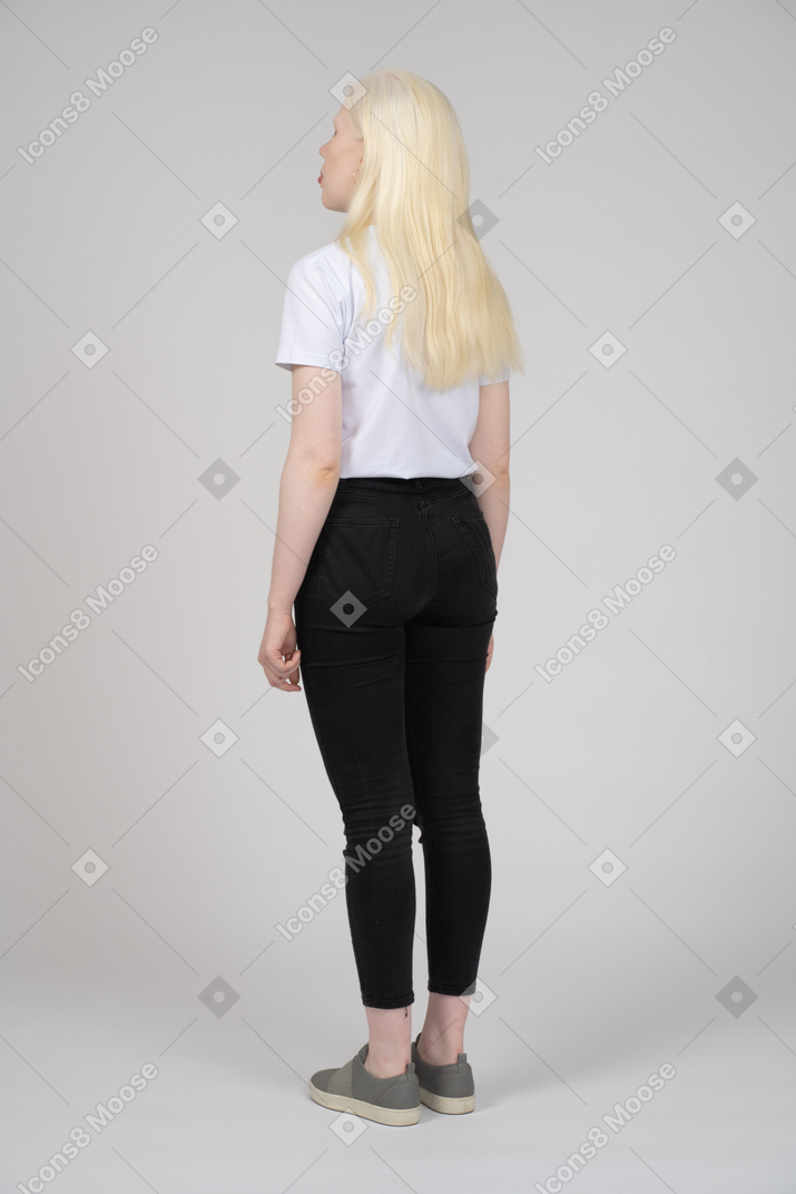 Rear view of a standing blonde lady