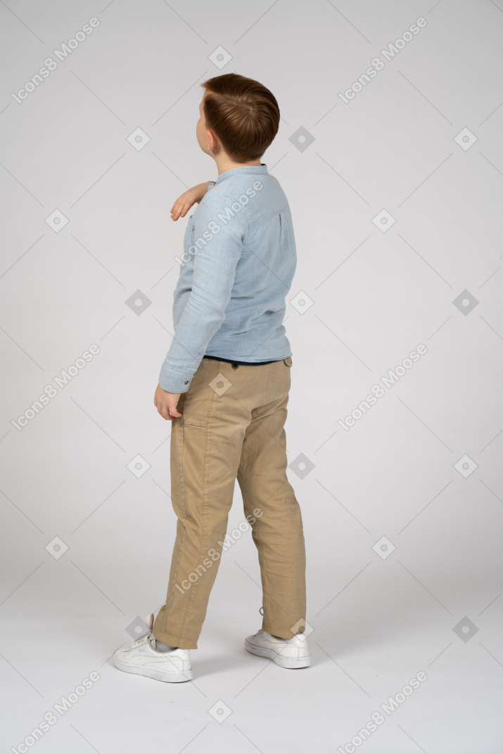 A boy in a blue shirt and khaki pants