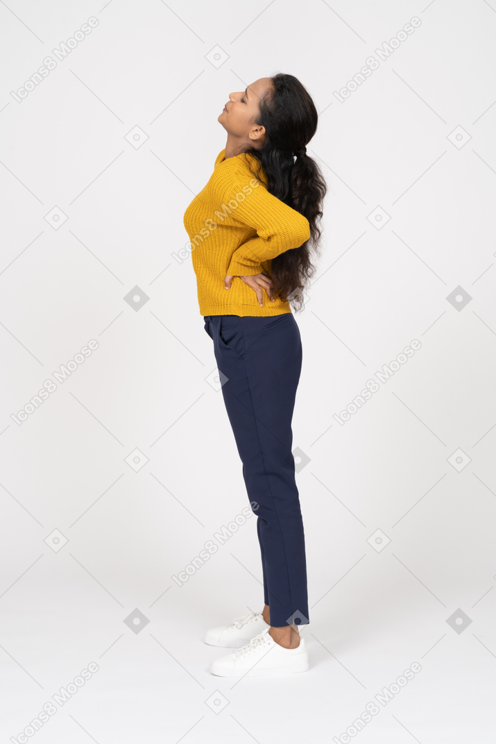 Side view of a girl in casual clothes stretching
