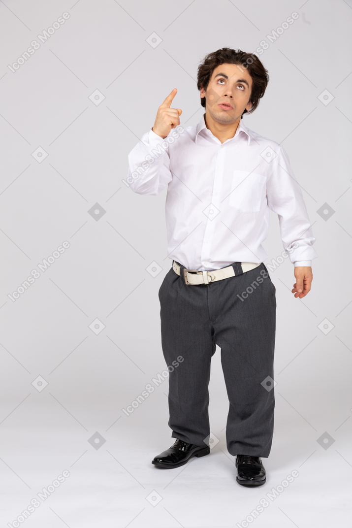 Young man looking and pointing up