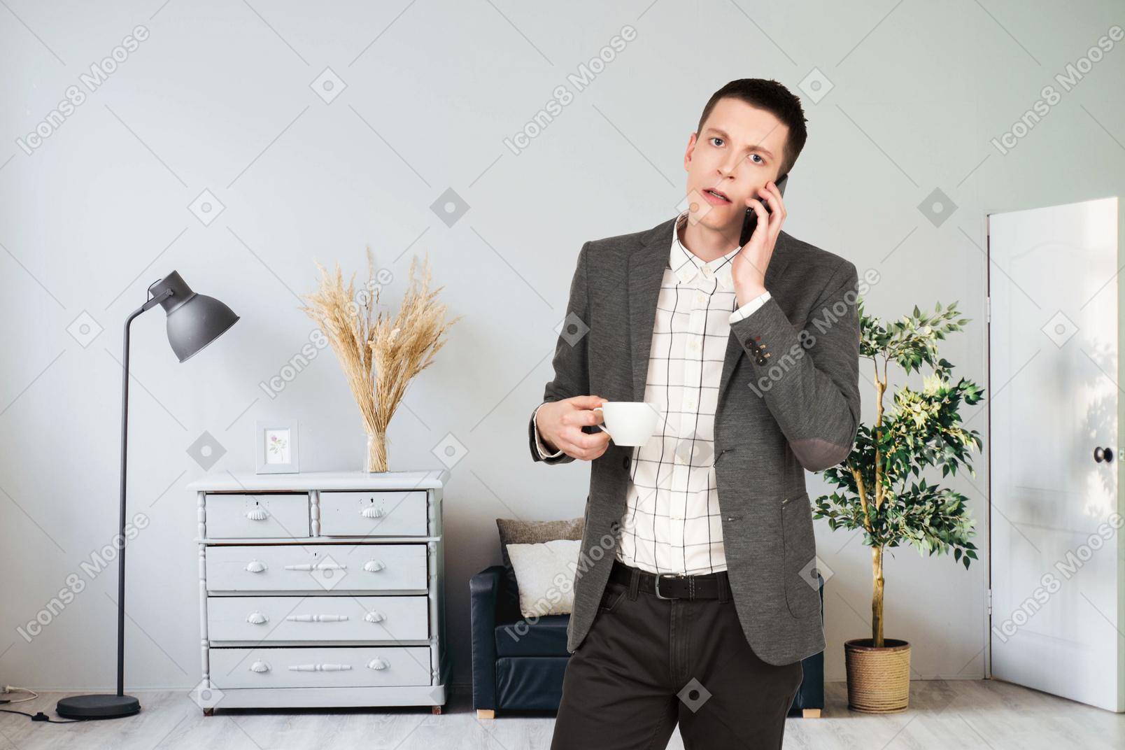 Man drinking coffee and talking on the phone