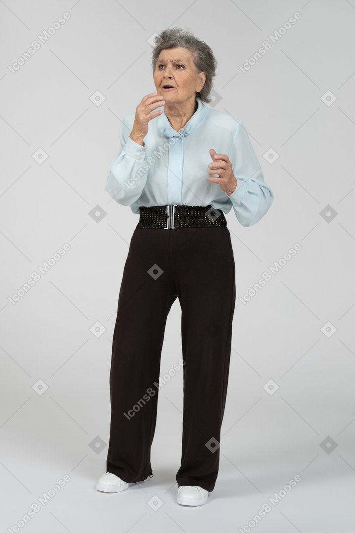 Front view of an old woman looking shocked and worried