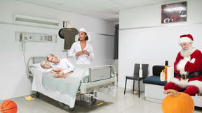 Santa claus, nurse and woman with mannequin in hospital room