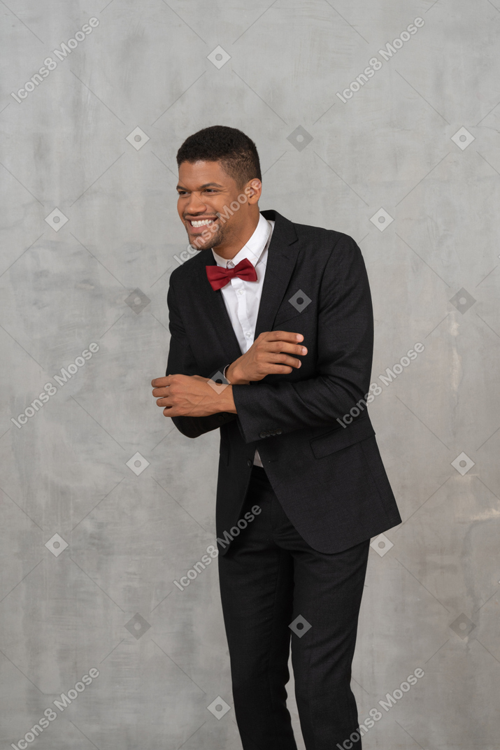 Man in black suit laughing
