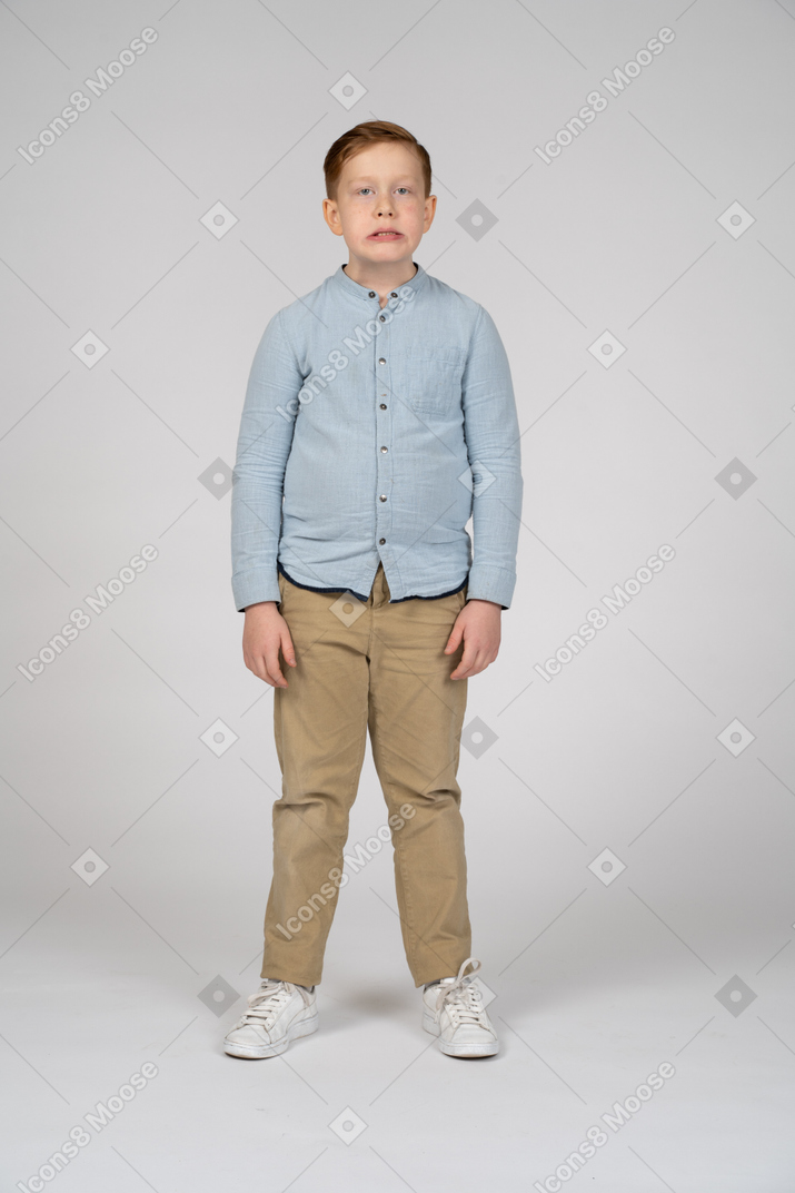 Front view of a boy making faces and looking at camera
