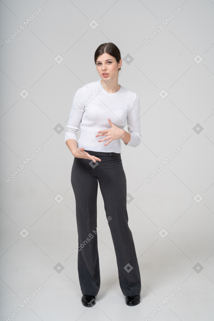 Front view of a young woman in suit gesturing