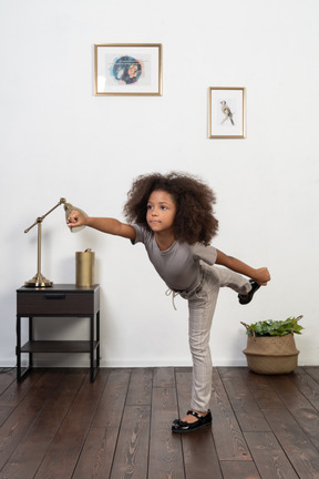 Good looking girl kid posing on the apartment background