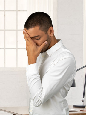 A man facepalming at the office