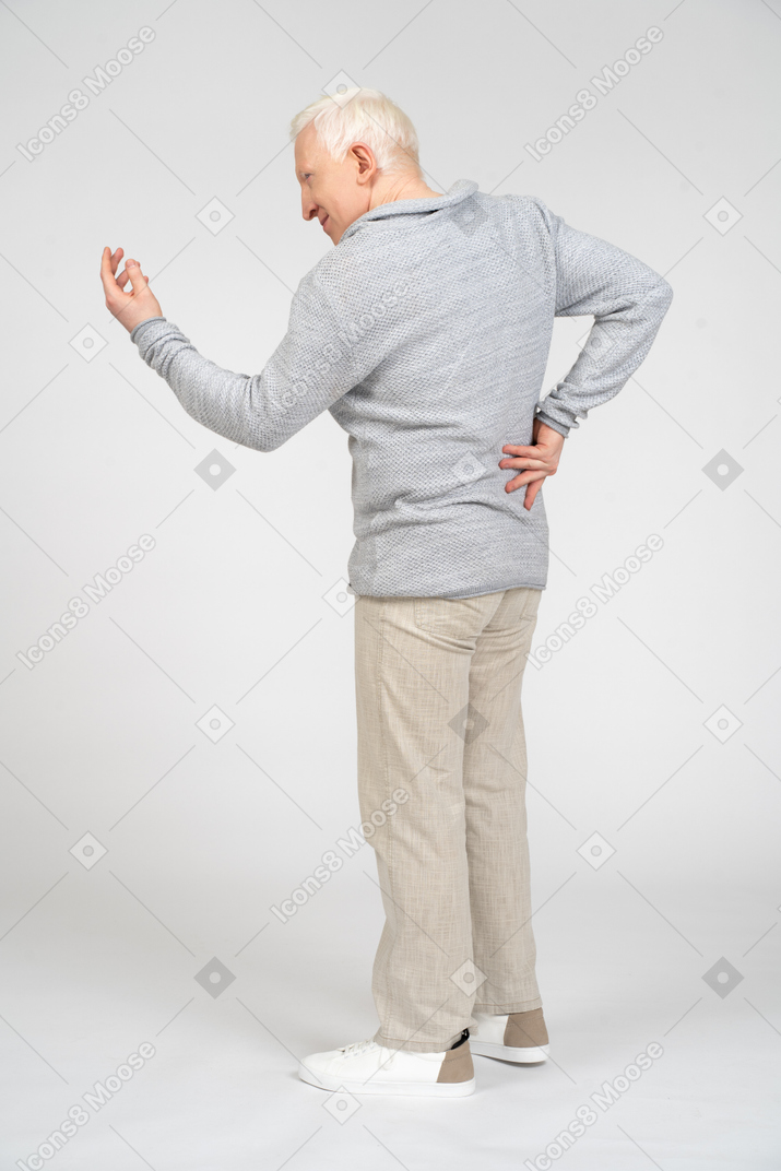 Rear view of man communciating and gesturing with hand