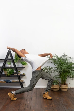 Handsome athletic man posing on the background of the apartment
