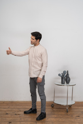 Side view of a man in casual clothes gesturing