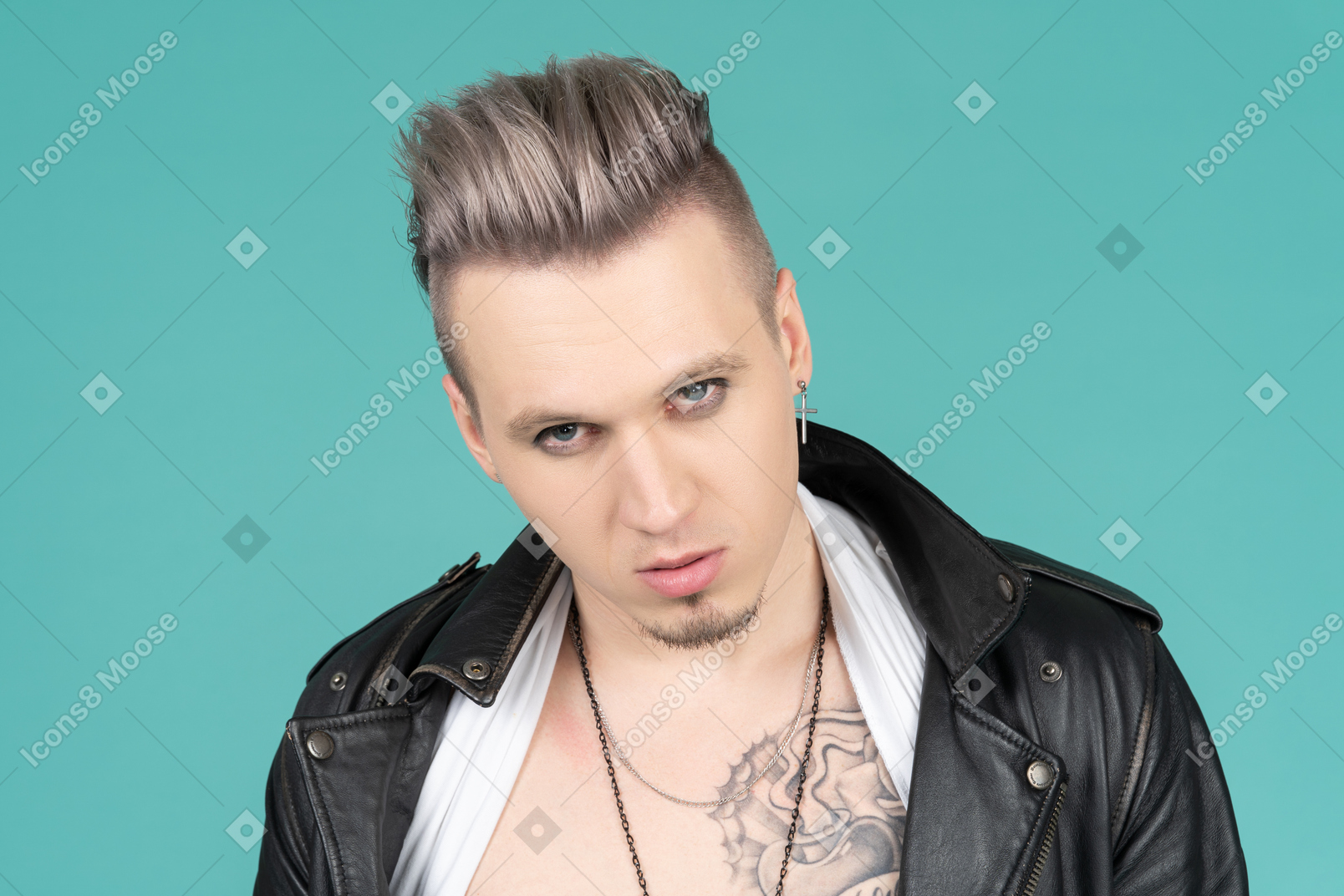 Barefaced male punk standing against camera