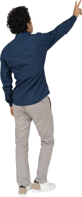 Rear view of a man in casual clothes showing v sign