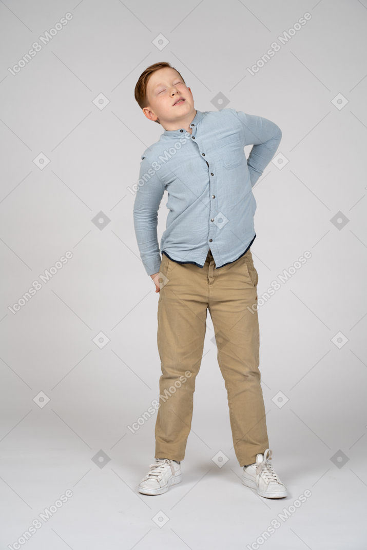 Front view of a boy stretching and looking up