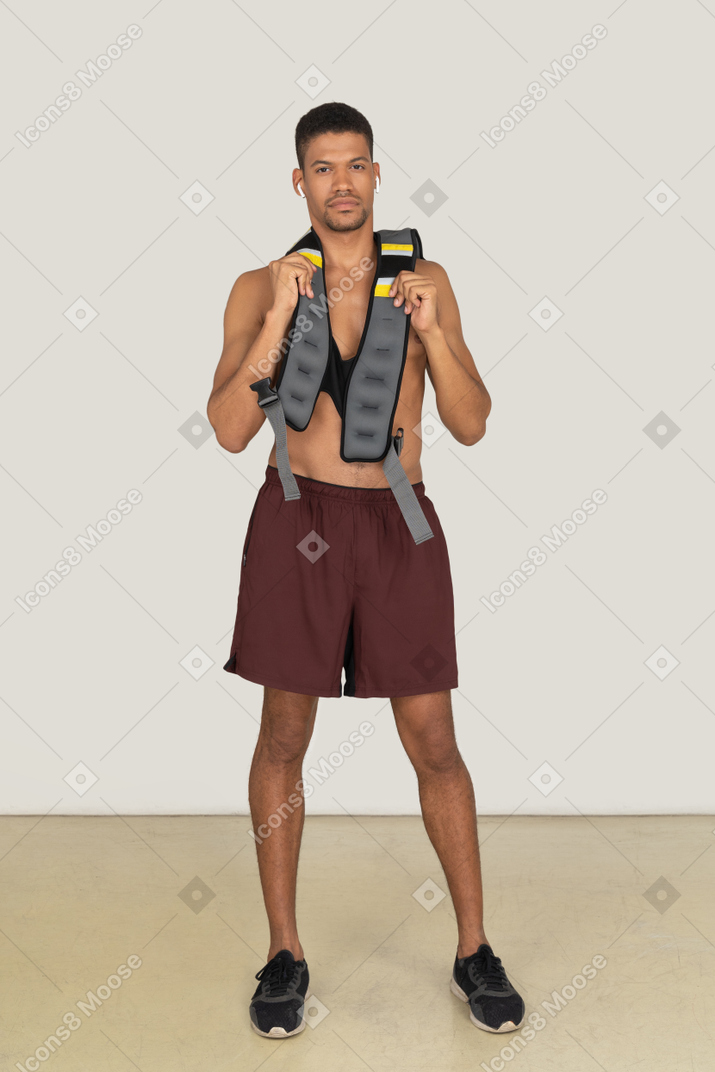 A frontal view of the athletic guy wearing a life vest and looking forward
