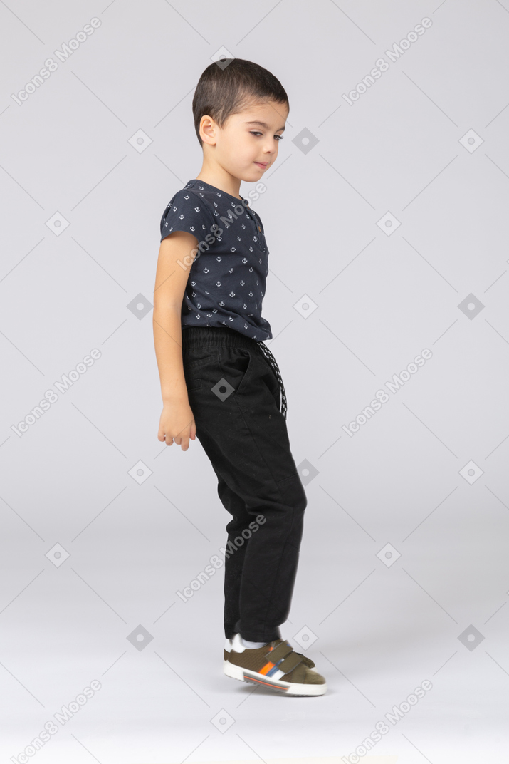 Side view of a boy in casual clothes jumping