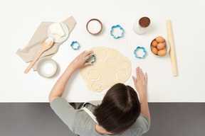 A female baker making cookies