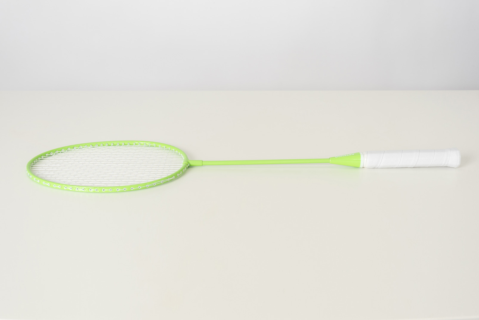 Green tennis racket on a white background