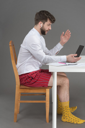 Businessman holding online meeting during pandemic