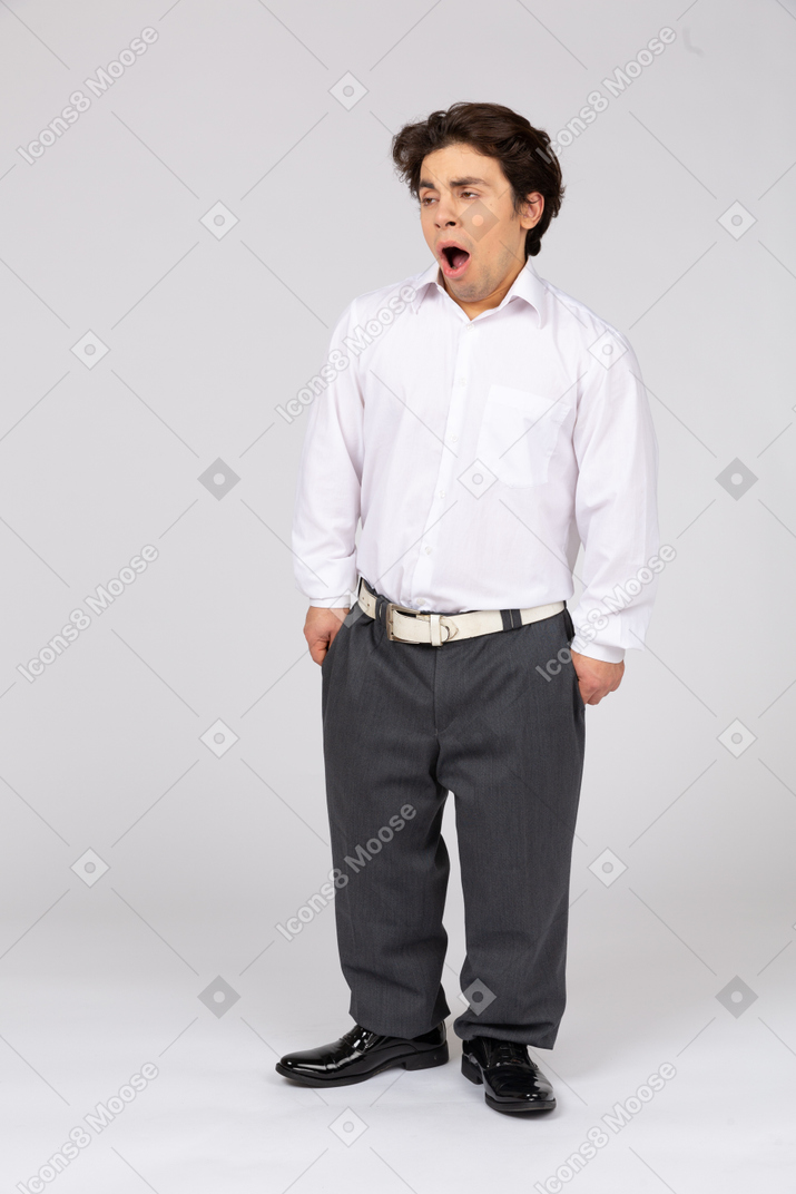 Front view of bored young man yawning