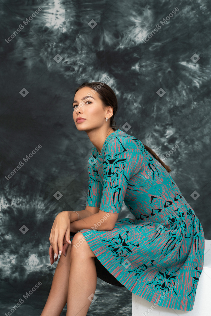 Young woman in blue sitting and thinking about the future