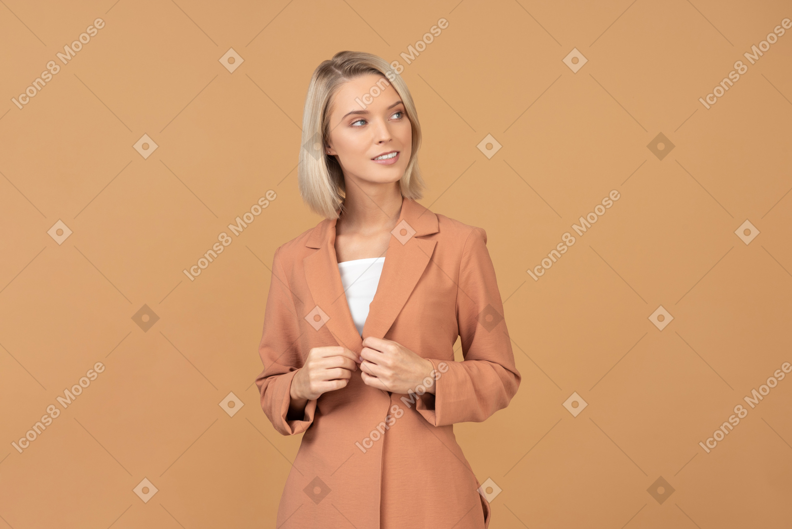 Pensive young woman in terracotta jacket