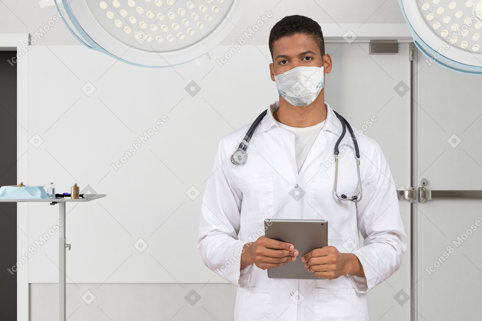 A male doctor in a white lab coat holding a tablet