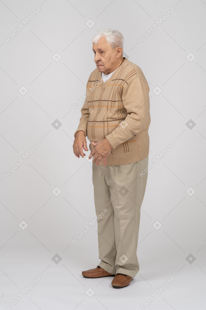 Front view of a confused old man in casual clothes