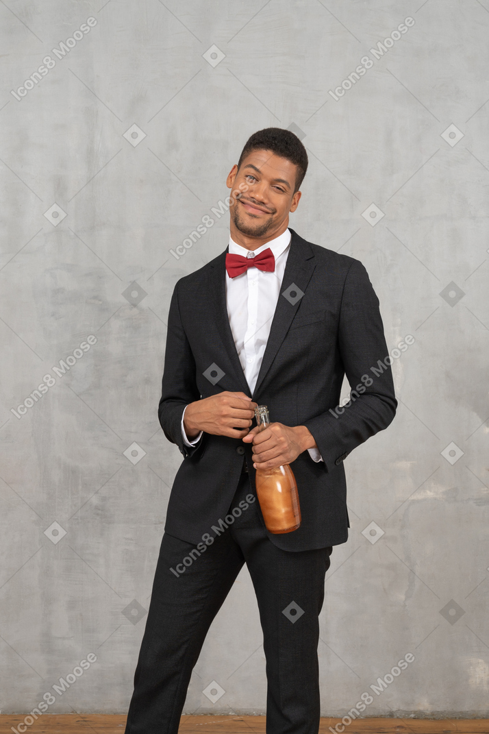 Tipsy young man smiling widely and looking at camera