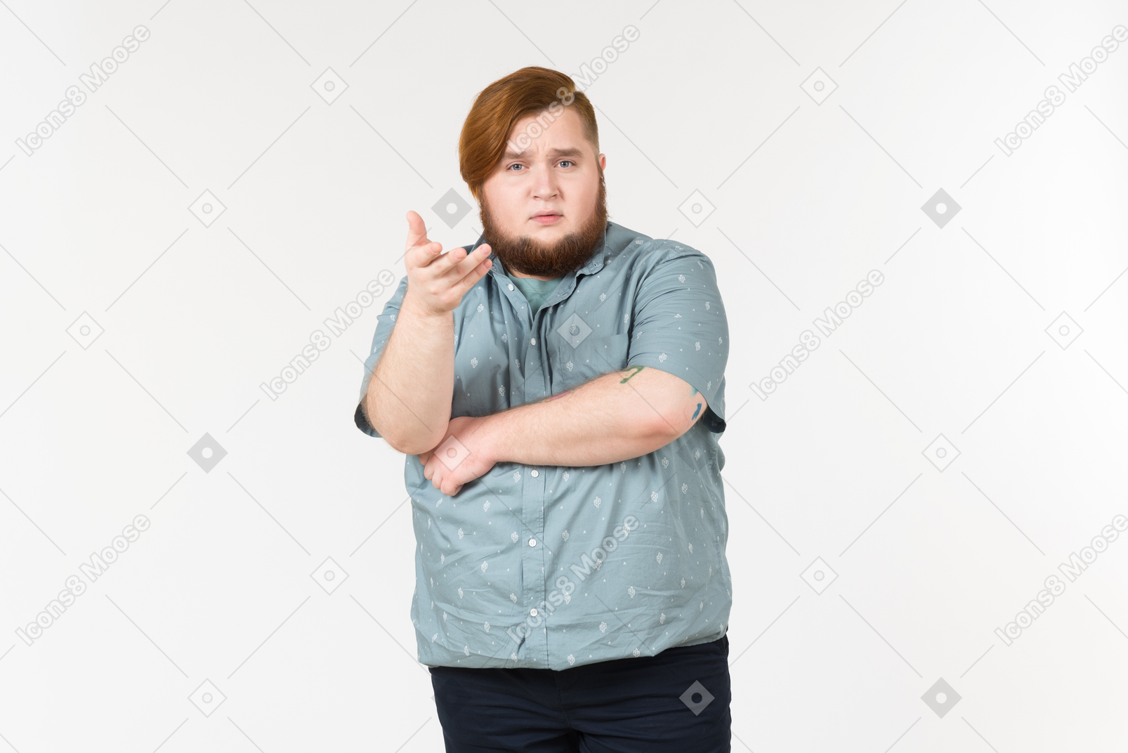 Pensive looking young overweight man standing with his hands crossed