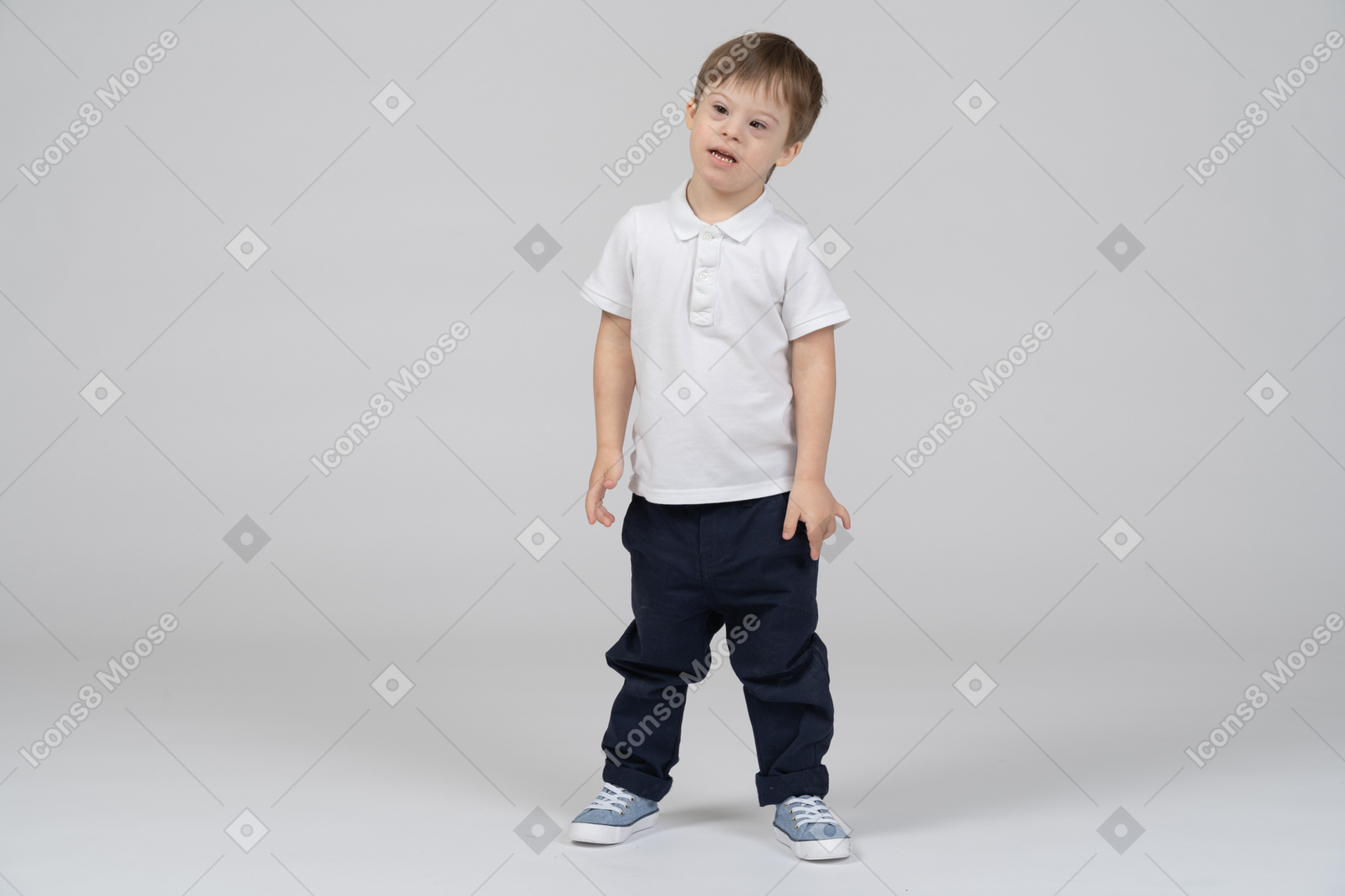 Little boy standing with arms at sides