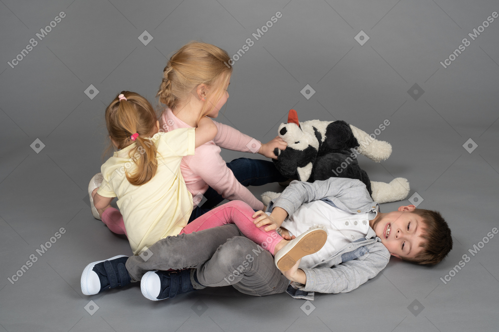 Three cute children playing with husky toy