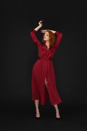 Young lady in red with arms up