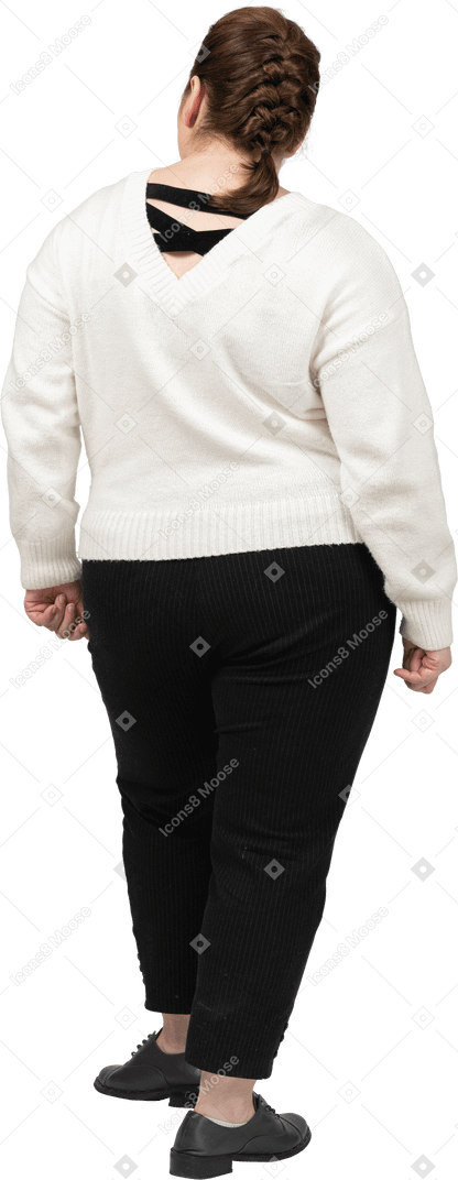 Plump woman in white sweater standing