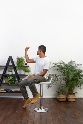 Good looking young man sitting on a chair