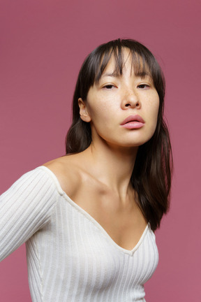 Three-quarter view of a bossy middle-aged female looking confidently at camera