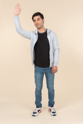 Young caucasian man waving